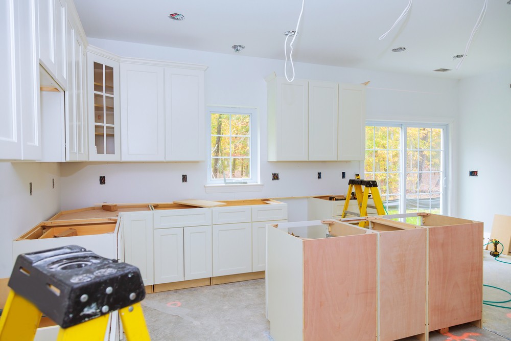 Custom-kitchen-cabinets-in-various-stages-of-installation-base-for-island-in-center-Installation-of-kitchen-cabinets